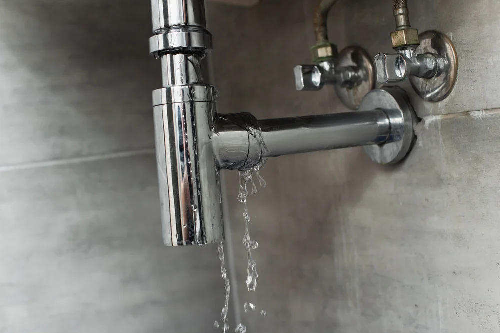 Water dripping from under-sink drain pipe joint — emergency plumbing repair Lake Gaston Area