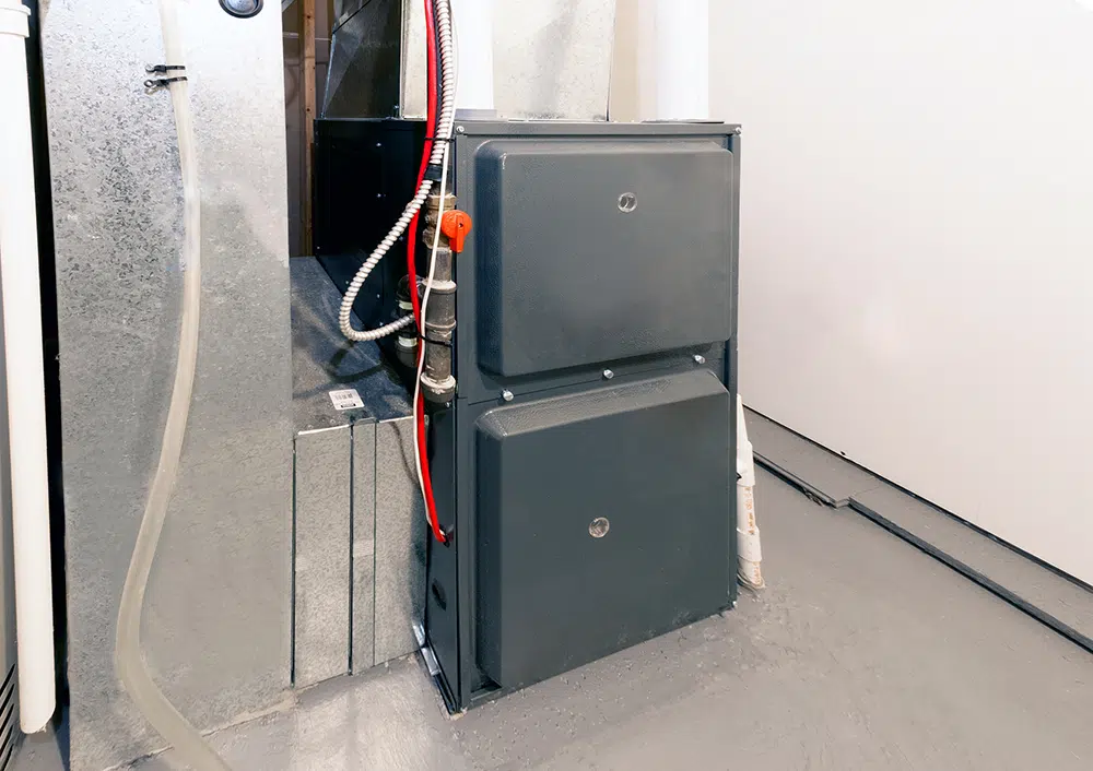 High-efficiency gas furnace in a basement utility room — furnace service near Lake Gaston Area