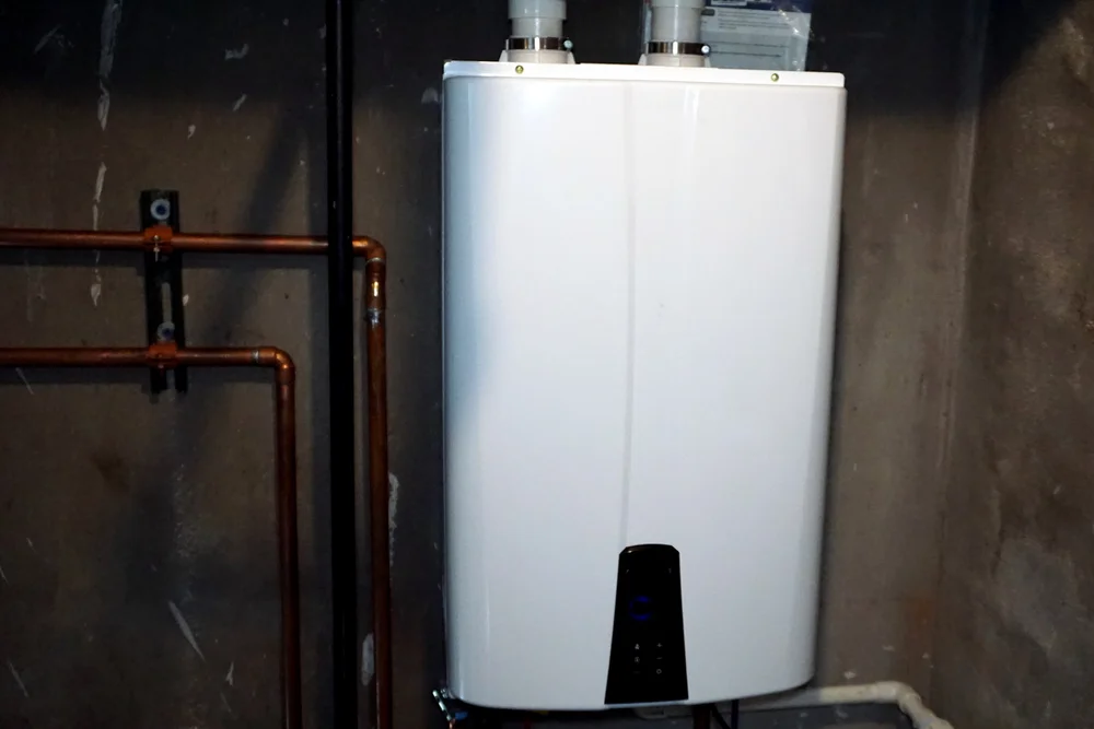 Wall-mounted tankless water heater with copper pipes — on-demand hot water Lake Gaston Area