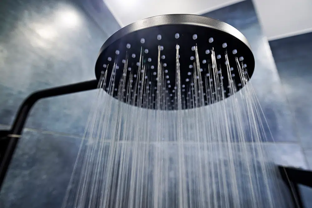 Hot water streams from a rain shower head — Lake Gaston Area water heater and plumbing service