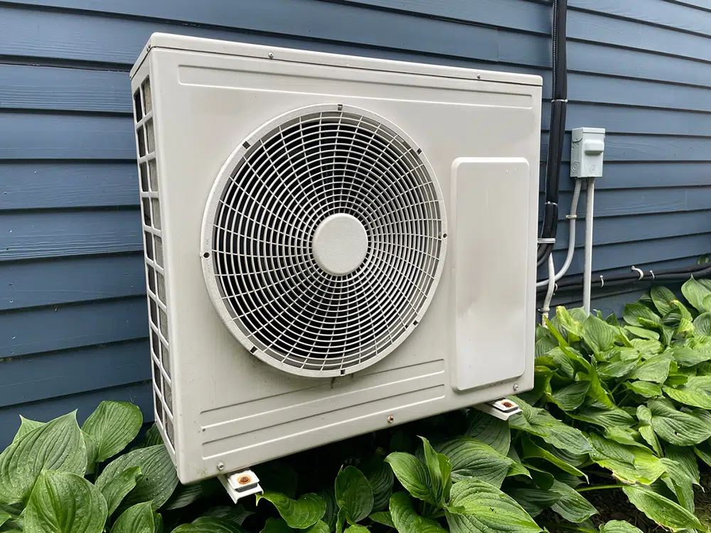 Ductless mini-split outdoor unit on home exterior — heat pump installation near Lake Gaston Area