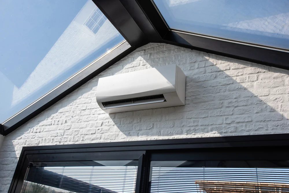 Wall-mounted ductless mini-split unit in a bright room — Lake Gaston Area heat pump installation