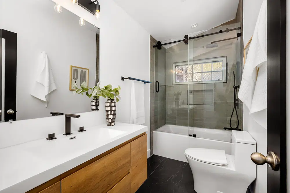 Modern bathroom with walk-in shower and double vanity — bathroom plumbing remodel Lake Gaston Area