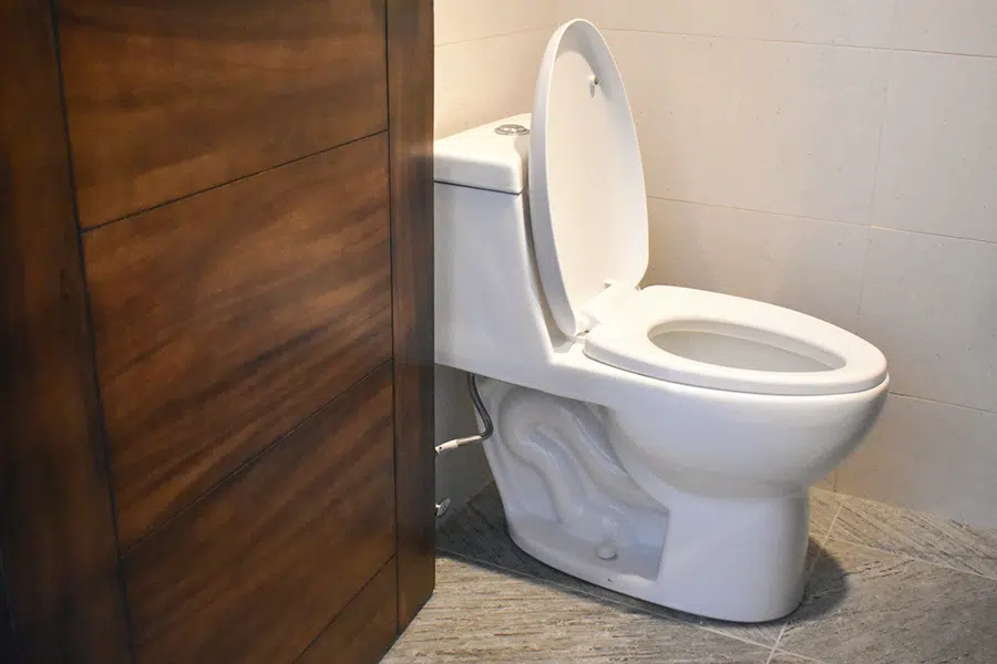 New white one-piece toilet in a tiled bathroom — toilet installation and repair near Lake Gaston