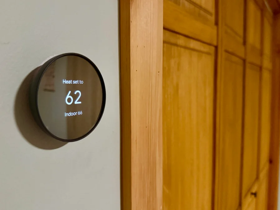 Smart thermostat on wall displaying 62 degrees — HVAC smart controls installed near Lake Gaston Area
