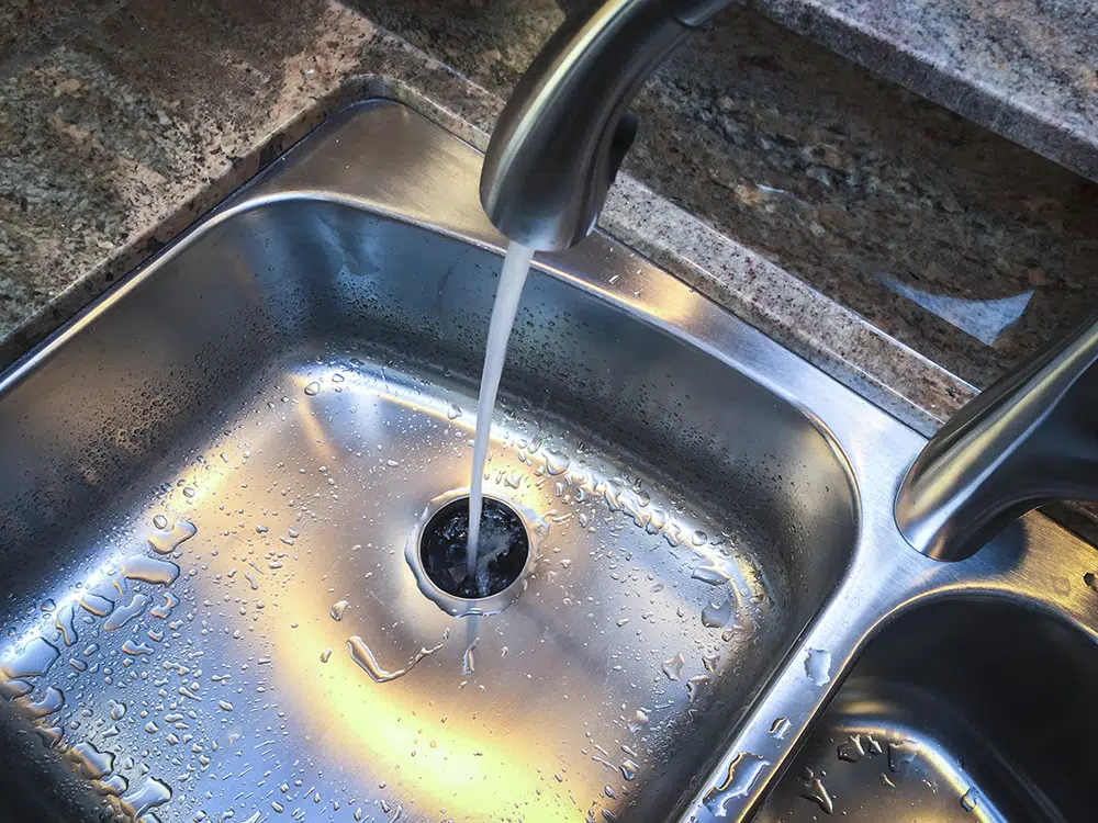 Clean kitchen sink with water flowing freely after Lake Gaston Area drain cleaning service