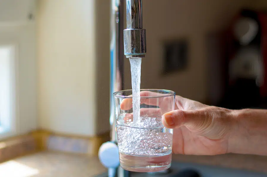 Filling a glass from a filtered tap — clean water filtration solutions in the Lake Gaston Area